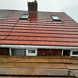 a red brick house with a red tiled roof