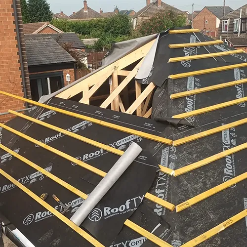 A roof that is being installed on a house.