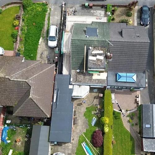 An aerial view of a house with a car parked in front of it.